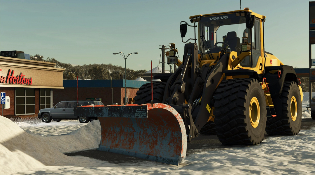 GoodRoads Snowplow mod clearing snow in FS25, featuring a Volvo loader.