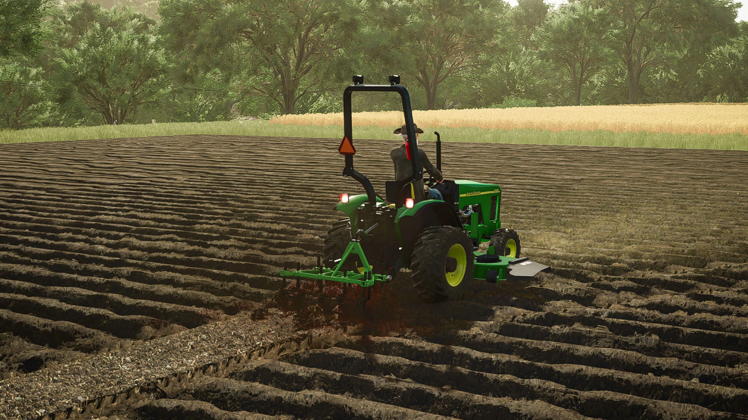 John Deere 4100 Compact Tractor mod in FS25 cultivating a field with trees in background.