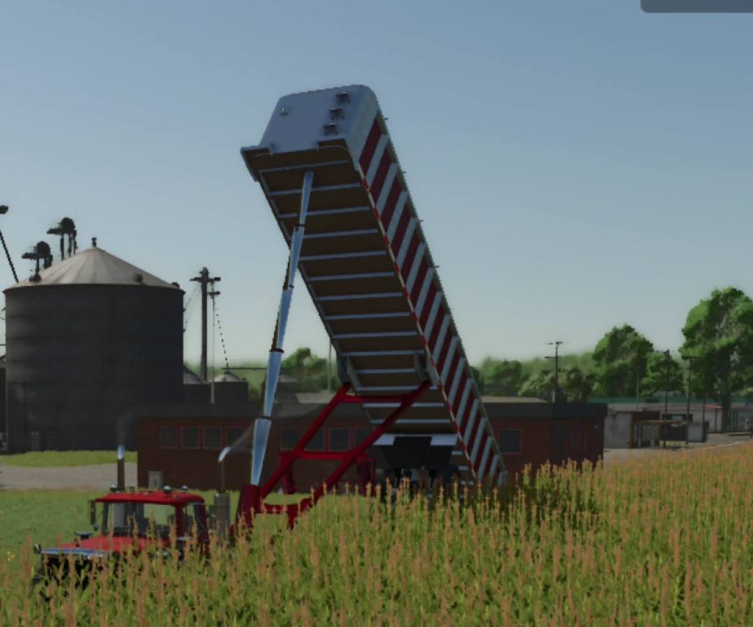 Lizard frameless end dump mod for FS25 shown in a farm setting with silo in the background.