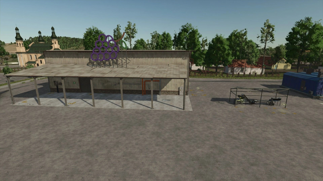 Production expansion mod in FS25, showcasing a facility with grape symbol on the roof amid rural buildings.