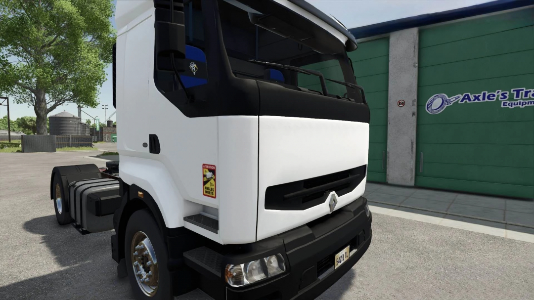 Renault Premium truck mod for FS25 at Axle's Truck Equipment. A white truck beside green building.