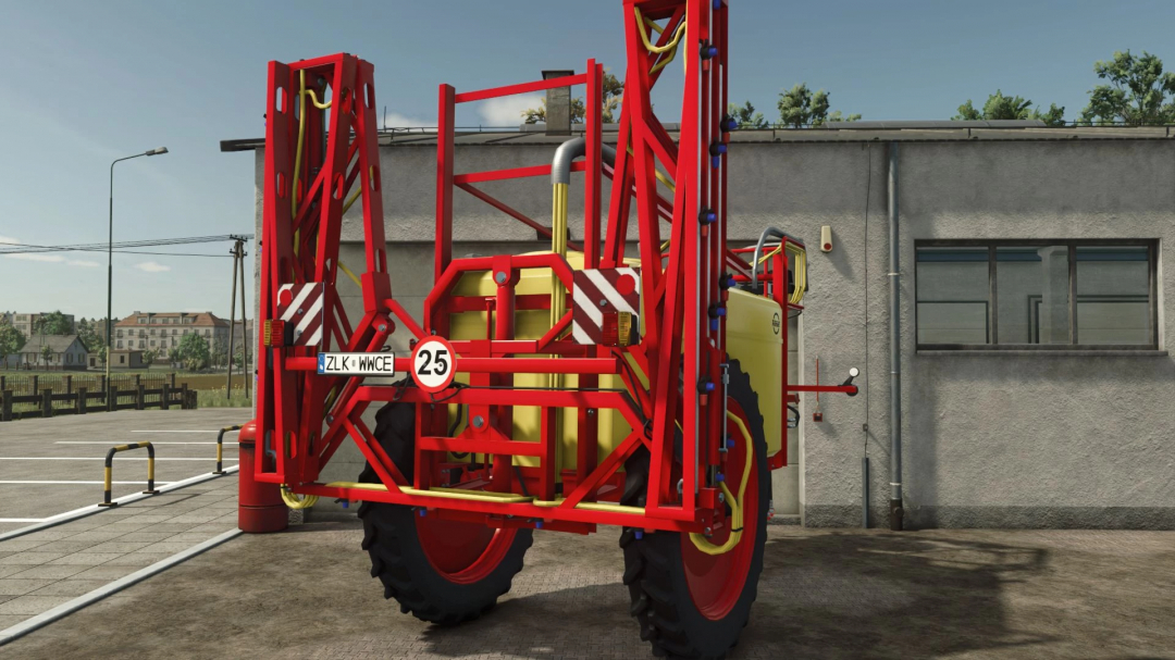 FS25 mod Unia Pilmet REX 2518 sprayer parked outside a building.