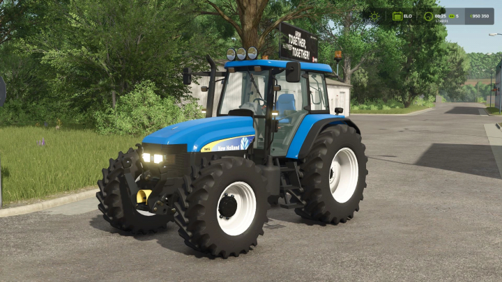 fs25-mods, New Holland TM Pack v1.1.0.0 mod in FS25 showcasing a blue tractor on a rural road.