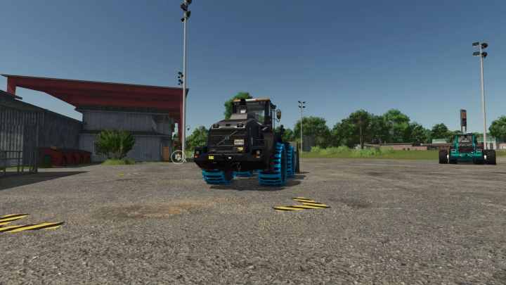 fs25-mods,  FS25 mod Volvo L120H v1.0.0.1 with blue tracks in a farm setting for Farming Simulator 25.