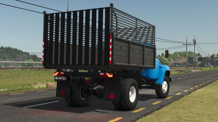 fs25-mods,  Zil 130 truck mod in Farming Simulator 25 with blue cab and black cargo bed parked on a road. FS25 mods.