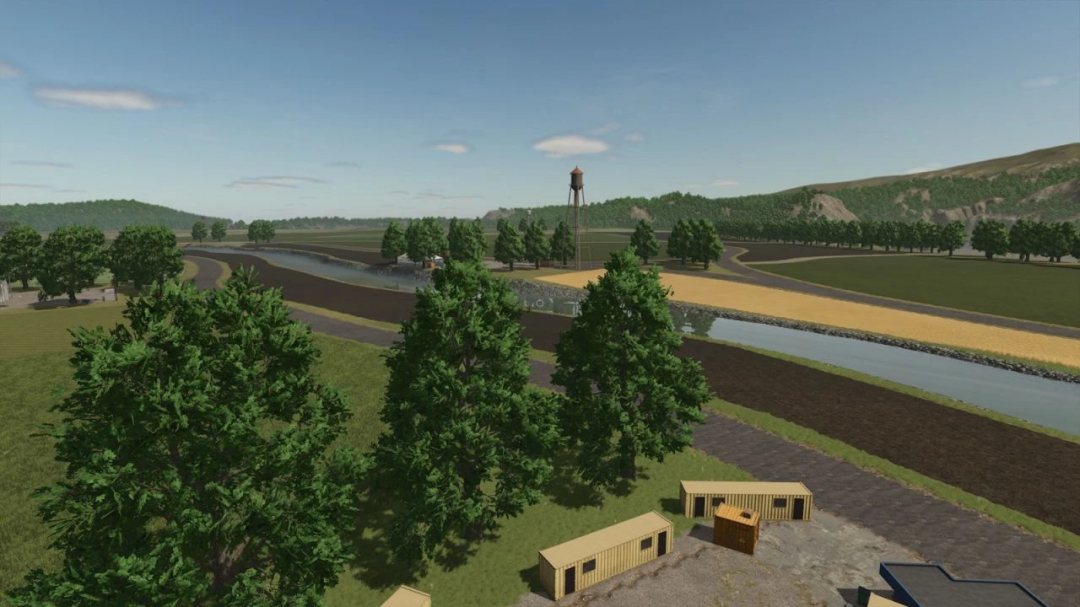 FS25 mod A Long The River Farm v1.0.0.0 featuring lush farmland, a river, and a water tower in Farming Simulator 25.