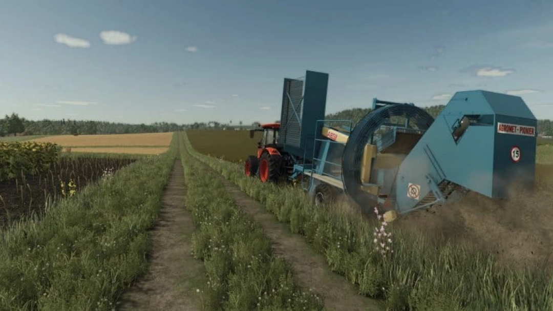 FS25 mod Agromet Z644 v1.0.0.0 in action, showcasing a field operation with a blue Agromet machine and a red tractor.