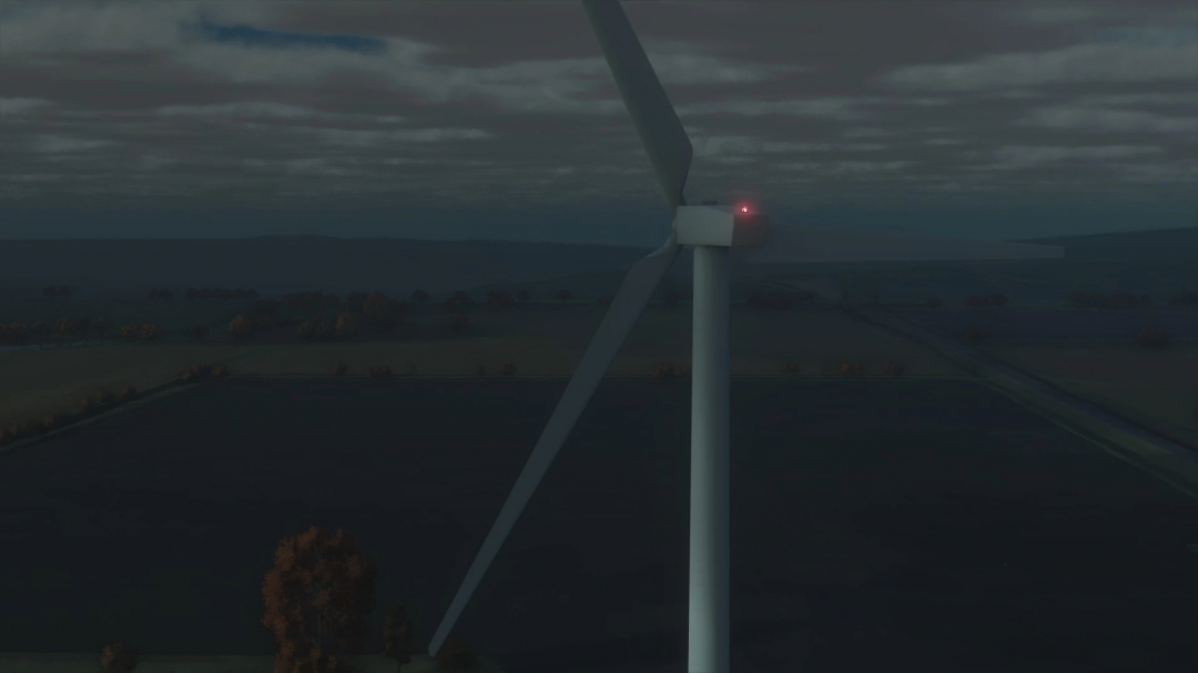 American Wind Tower mod in FS25 at night, with a lit red light on top, set against a dark rural landscape.