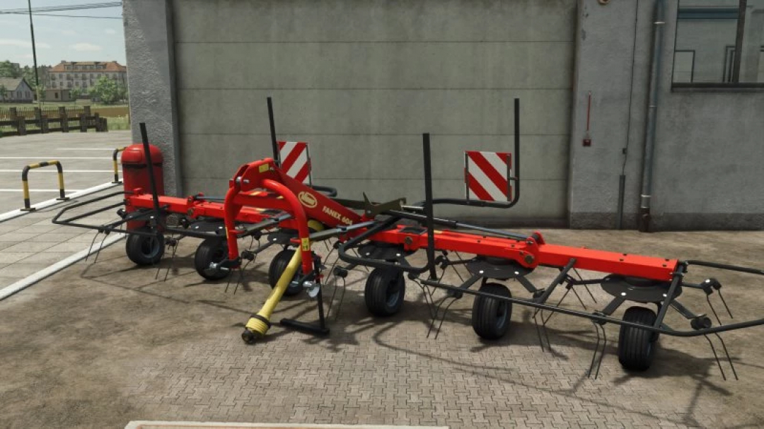 FS25 Vicon Fanex 604 mod in Farming Simulator 25, showcasing red agricultural machinery positioned outdoors.