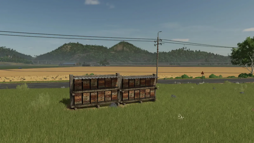 FS25 mods: Fast Honey Production v1.0.0.0, beehives in a field with mountains in Farming Simulator 25.