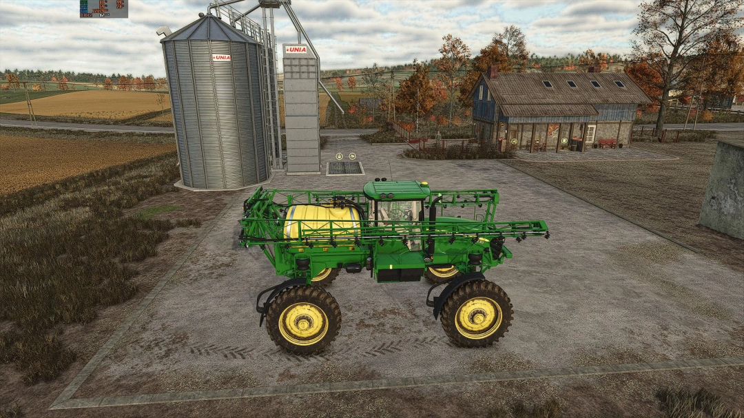 FS25 mod: John Deere 4730 sprayer near silos in Farming Simulator 25.