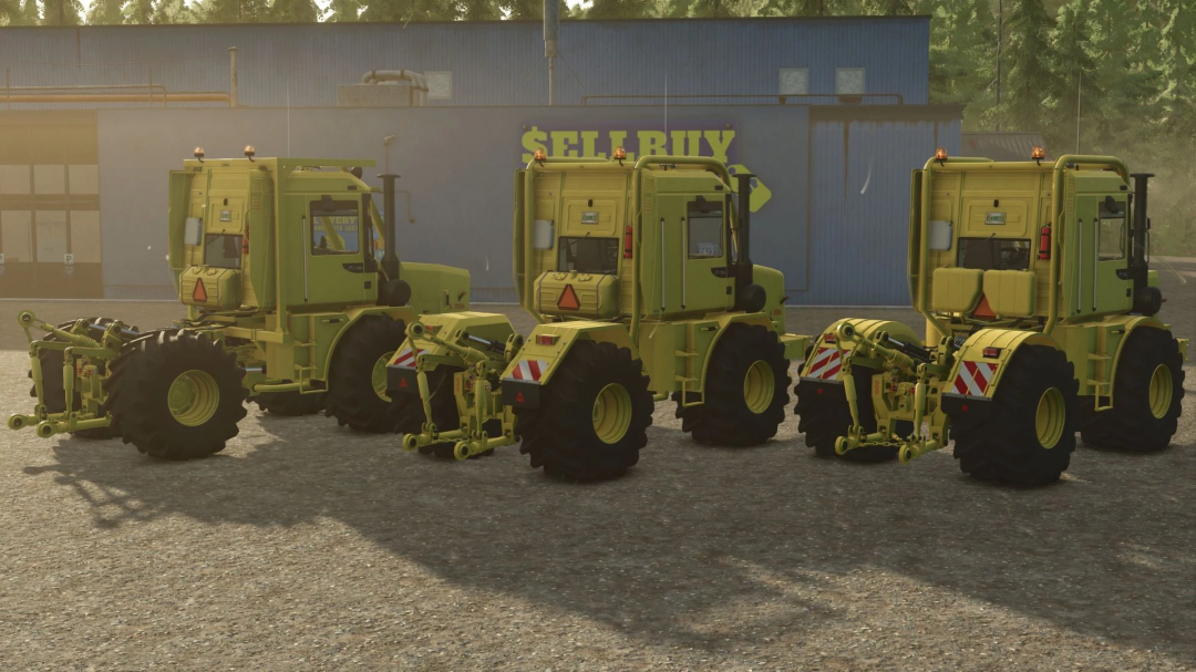 FS25 mod Kirovets Magnum K-700A-M tractors in Farming Simulator 25. Three yellow tractors parked near a barn.