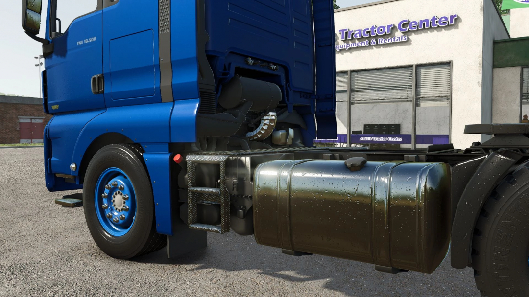 Close-up of a blue MAN TGX 18500 truck mod in Farming Simulator 25, parked beside a tractor center.