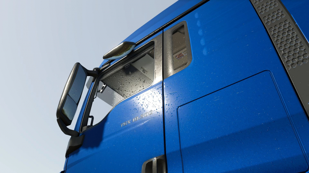 Close-up of blue MAN TGX 18500 truck mod in Farming Simulator 25 with water droplets on the window. FS25 mods.