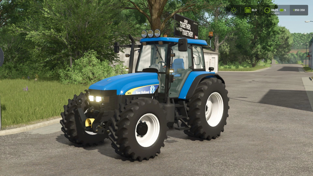 New Holland TM Pack v1.1.0.0 mod in FS25 showcasing a blue tractor on a rural road.