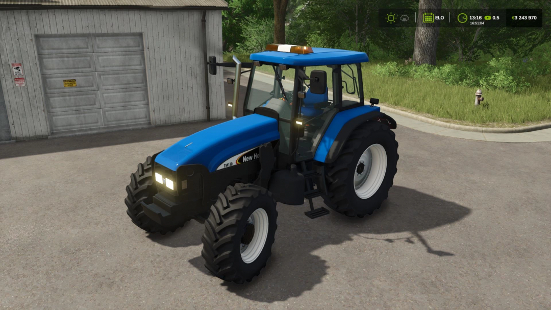 New Holland TM Pack tractor in Farming Simulator 25 mod v1.1.0.0 parked near a shed.