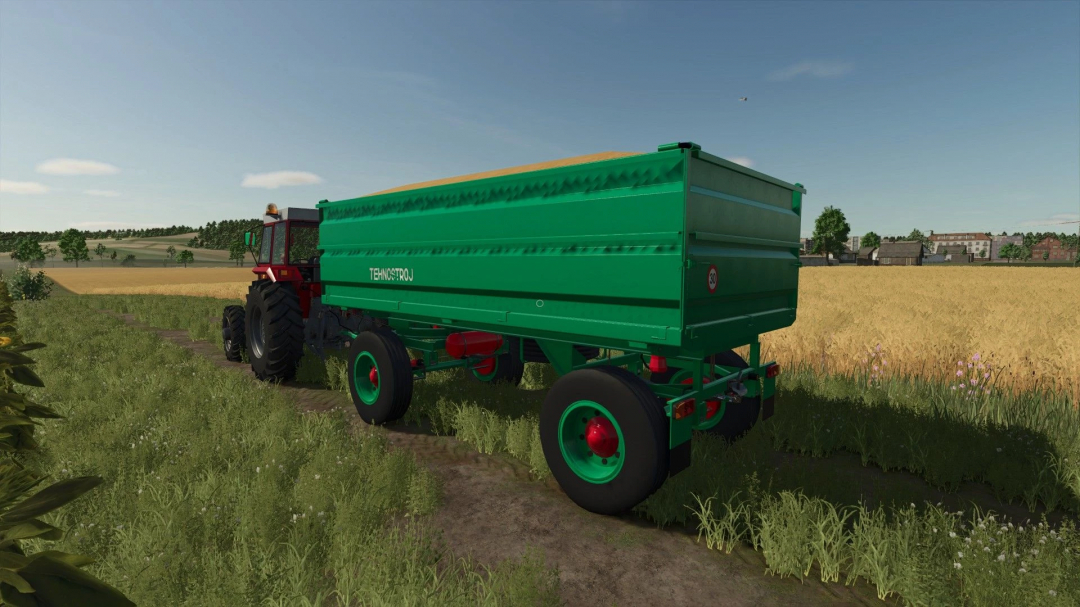 Tehnostroj 7t trailer mod in FS25, displayed on a farm path beside wheat fields.