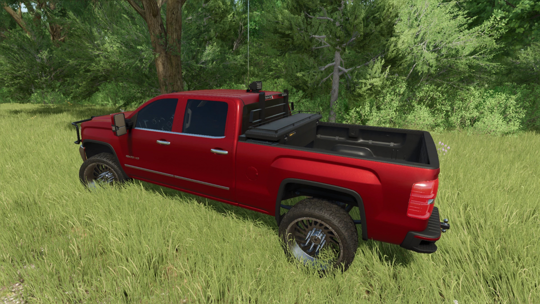 Red 2018 GMC Sierra 2500 mod in FS25, shown in a grassy field, enhancing Farming Simulator 25 gameplay.