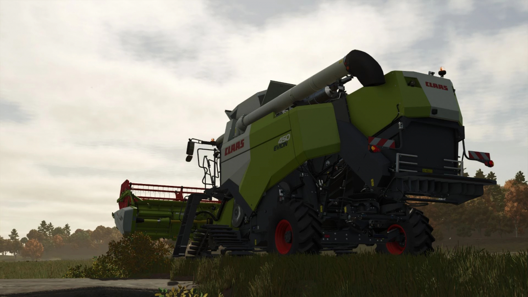 Claas Evion 450 Rice harvester mod in FS25, showcasing detailed machinery against a rural landscape.