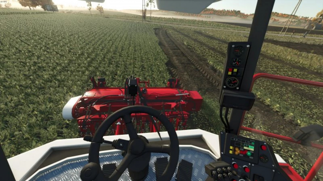 FS25 Vervaet 17t harvester in a Farming Simulator 25 field, cockpit view highlighting controls.