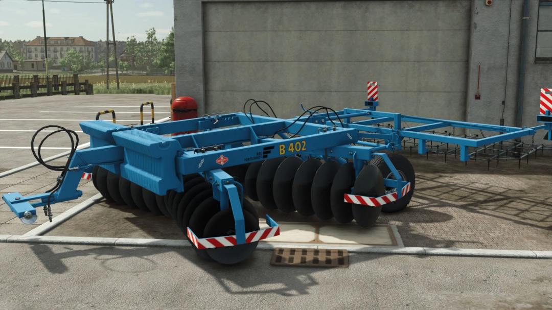 Fortschritt B402 v1.0.0.0 mod for Farming Simulator 25, showcasing a blue agricultural disc harrow in a farm setting.