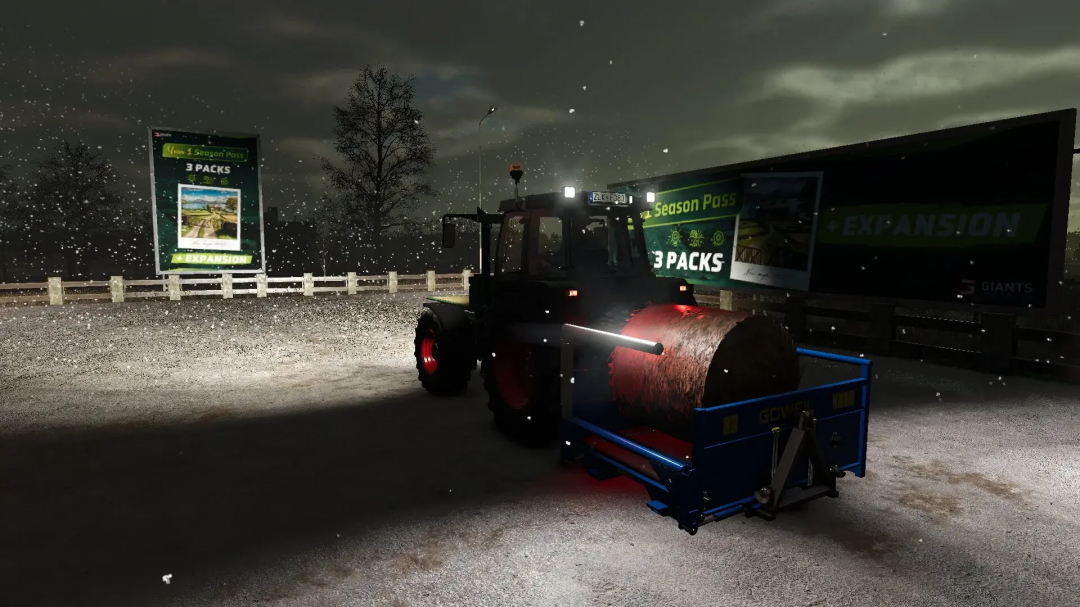 FS25 Göweil RBA bale shredder mod under snowfall, illuminated by tractor lights at night.