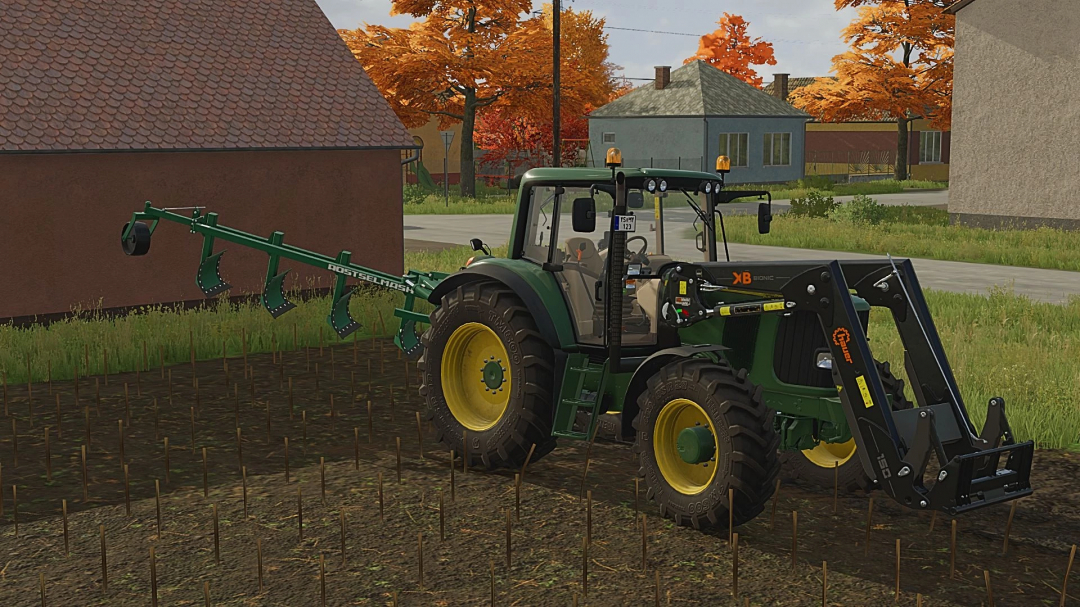 John Deere 6x20 Topola tractor mod in FS22, cultivating a field next to a rural house in autumn scenery.