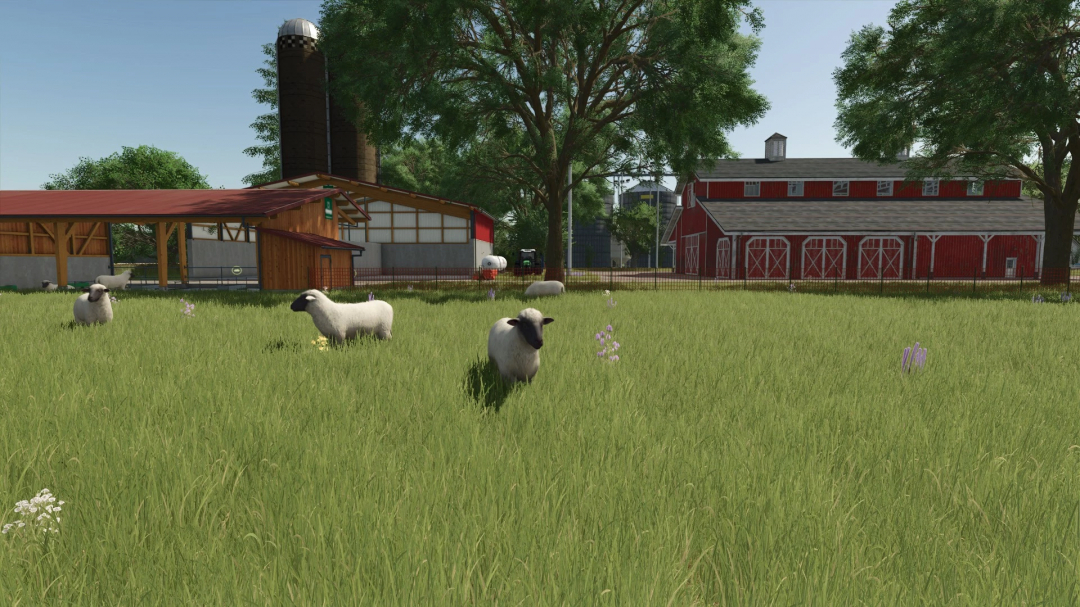 FS25 Legacy Township v1.0.0.0 mod showing sheep grazing in a green field near red barns and silos.