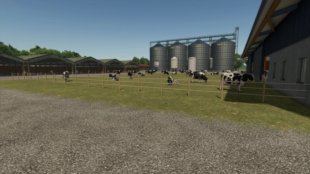 FS25 mod Legacy Township v1.0.0.0 with cows in a pasture, silos in the background.