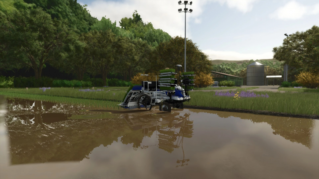 FS25 Legacy Township mod showcasing a rice field with planting machinery near a farm silo.