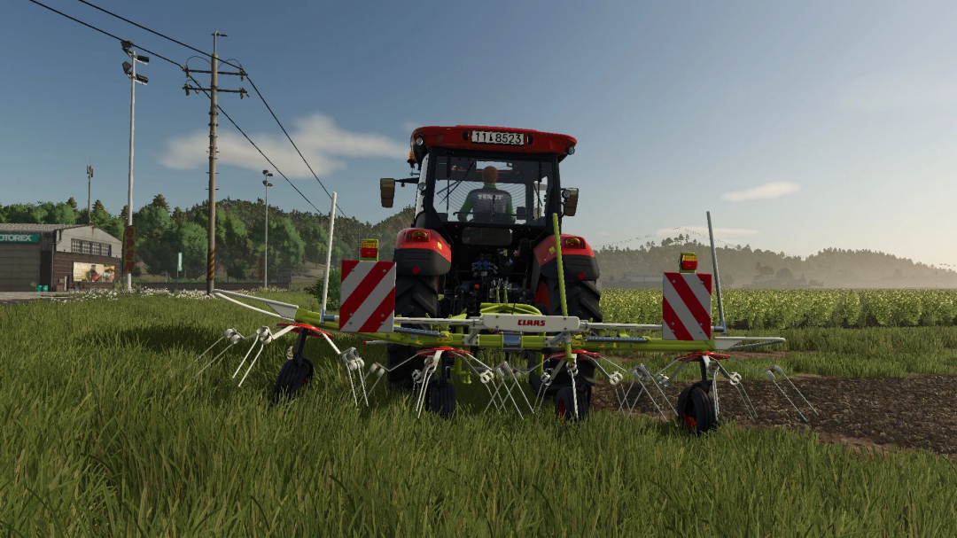 FS25 mod Pöttinger AlpinHit44 v1.0.0.0 with a tractor in a grassy field.