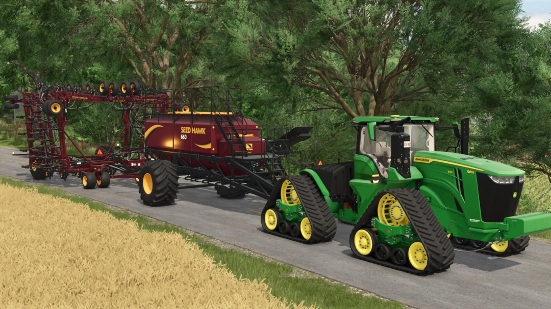 FS25 Seed Hawk Pack v1.0.0.1 with green tractor on road, trees in background.