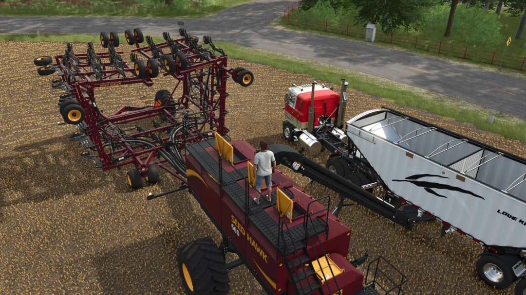 FS25 mod Seed Hawk Pack v1.0.0.1 featuring farming equipment and a truck in a field.