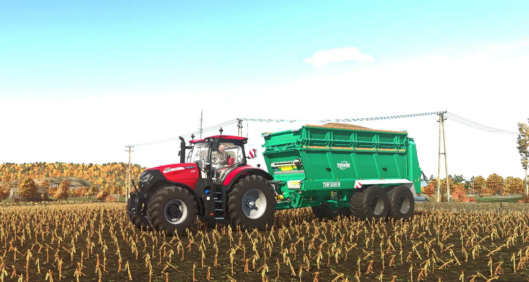 FS25 mod Tebbe TSW 6240W manure spreader attached to a red tractor in a harvested field.