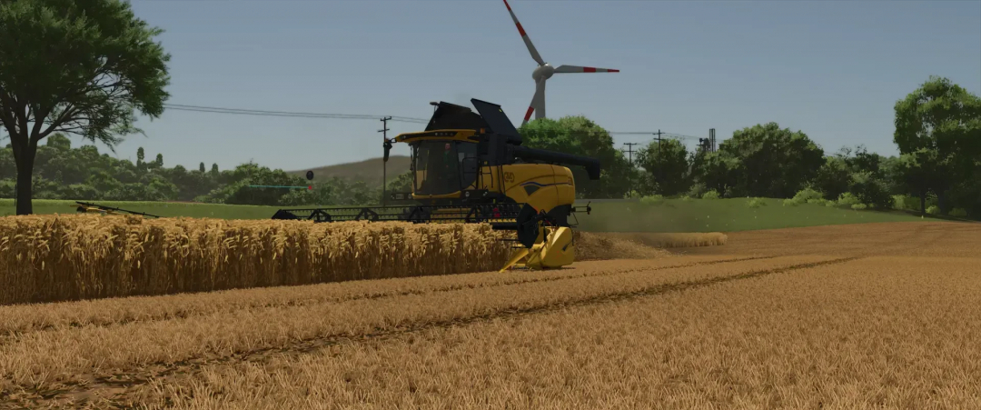 FS25 mod Varifeed 28ft harvester in wheat field with wind turbine in background.