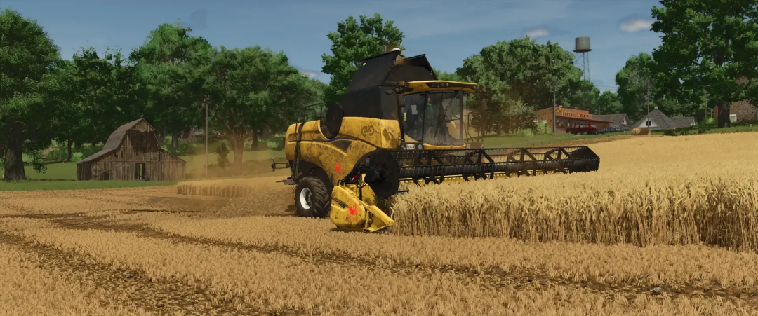 FS25 mod featuring a Varifeed 28ft harvester working in a wheat field with a rustic barn and trees in the background.