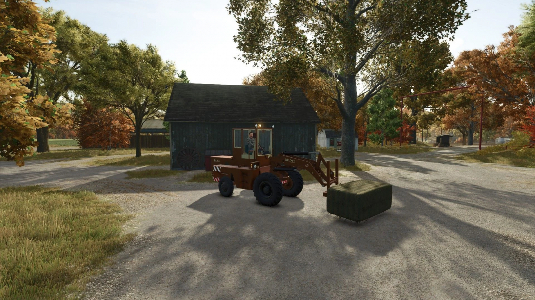 ZTS UN-053 loader from FS25 mods carrying hay bale in autumn landscape in Farming Simulator 25.