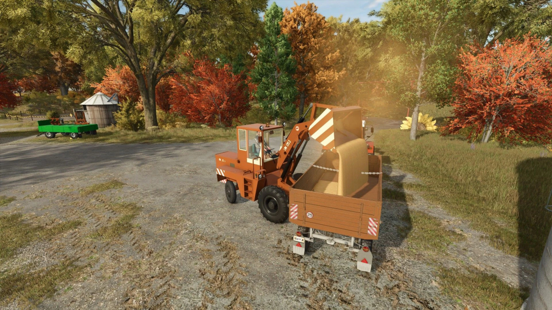 The ZTS UN-053 Pack mod in FS25, featuring a loader unloading hay bales in a vibrant autumn setting.