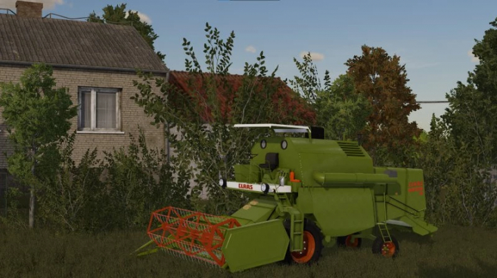 fs22-mods,  Claas Mercator 50 combine mod in FS22 near a rustic house.