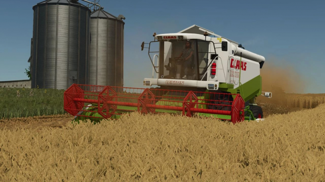 CLAAS Lexion 410-480 harvesting wheat in FS25 mod with silos in background.