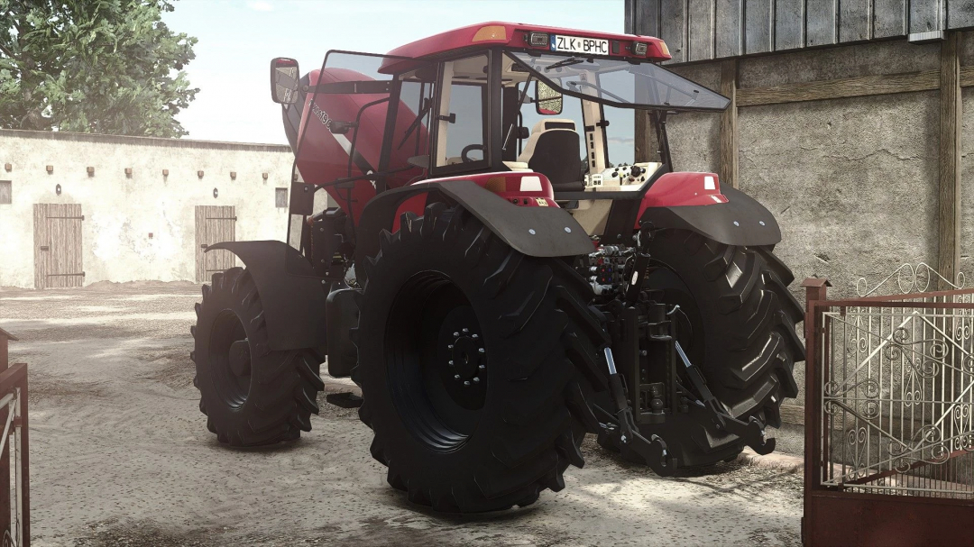 Case IH MXM 190 tractor mod in FS25, view of rear and large tires outside a farm building