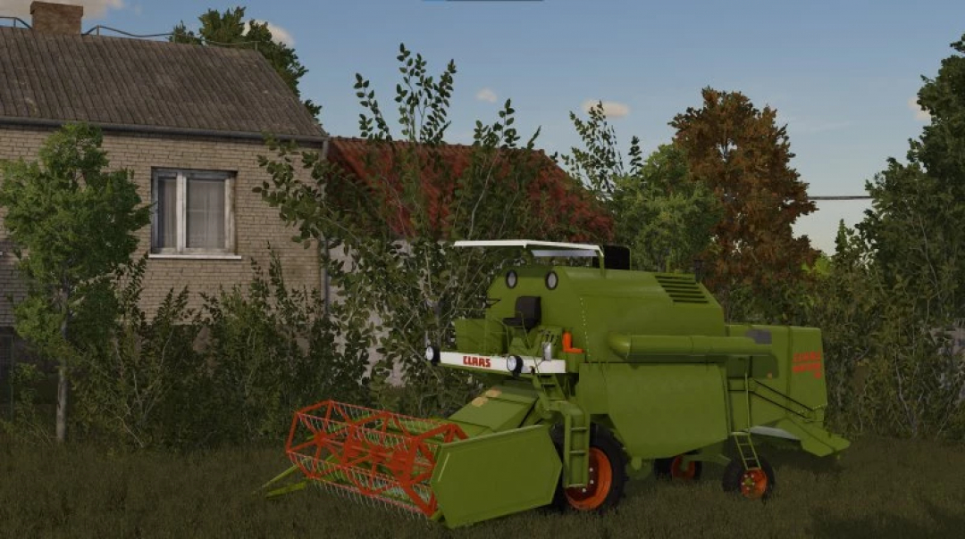 Claas Mercator 50 combine mod in FS22 near a rustic house.