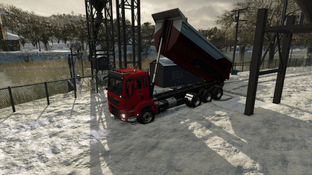 FS25 Man Dumper v1.0.0.0 mod, showcasing a red dump truck unloading on a snowy landscape in Farming Simulator 25.