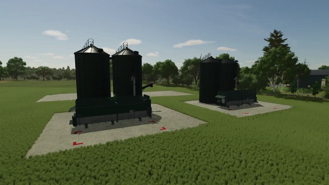 Feed mixer mod v1.0.0.0 in FS25 showing large silos in a grassy field.