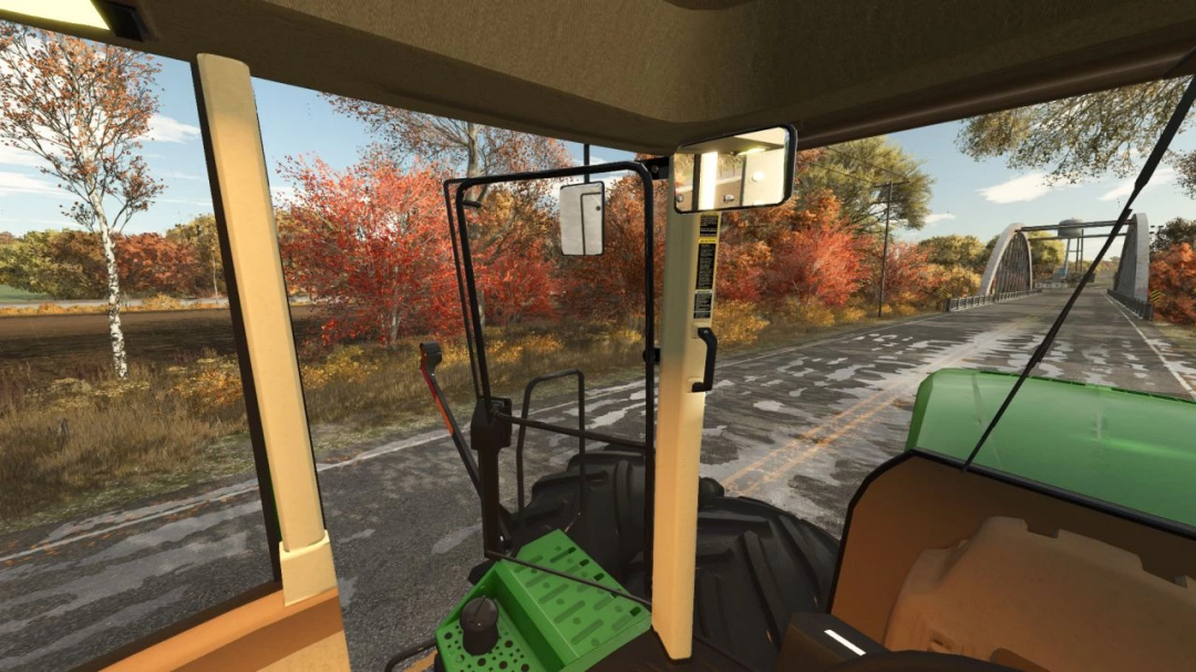 Inside view of John Deere tractor from FS25 mod, showing autumn landscape and road.