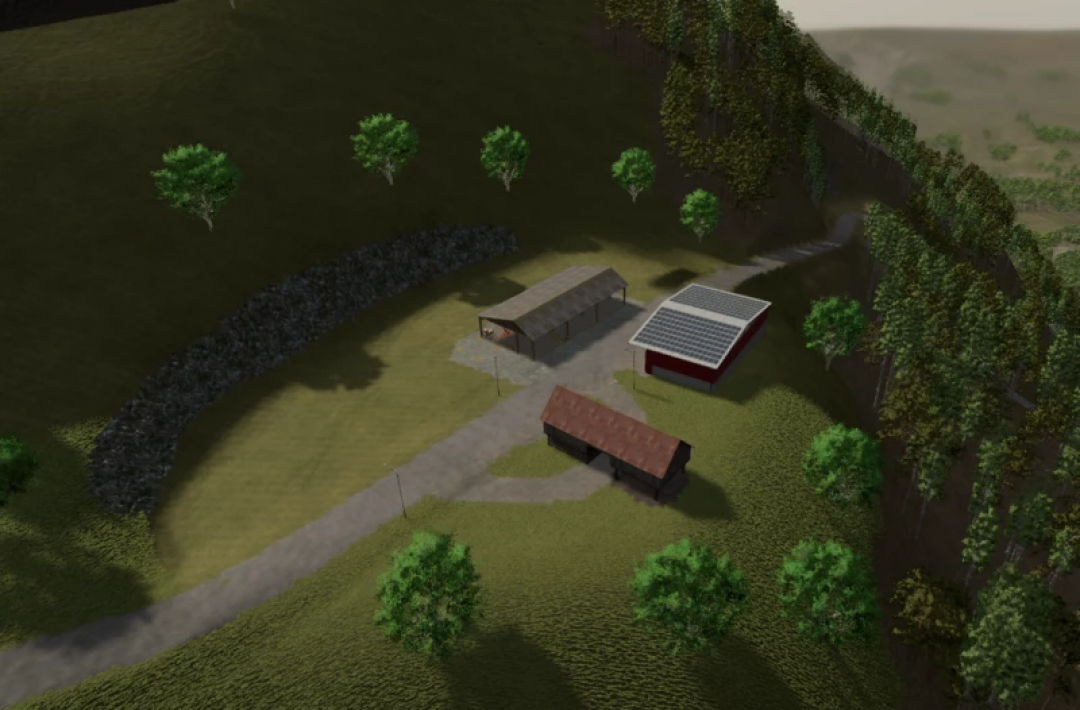 Aerial view of a farm setup in the FS25 Kaprun v2.1.2.0 mod, featuring a barn, solar-roof building, and lush forest landscape.