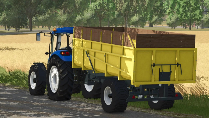 fs25-mods,  FS25 mod 30 Ton Trailer v1.0.0.0 in yellow attached to a blue tractor on a road in Farming Simulator 25.