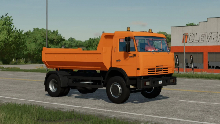 fs22-mods,  FS22 mod Kamaz 43255 orange truck parked in a garage lot in Farming Simulator 22.