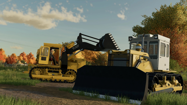 fs22-mods, FS22 T-130 mod showcasing two yellow bulldozers in a scenic autumn field in Farming Simulator 22.