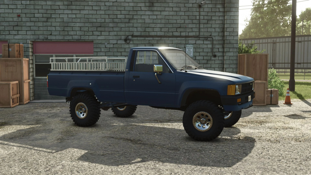 1984 Toyota Hilux mod for Farming Simulator 25, parked by a brick building.